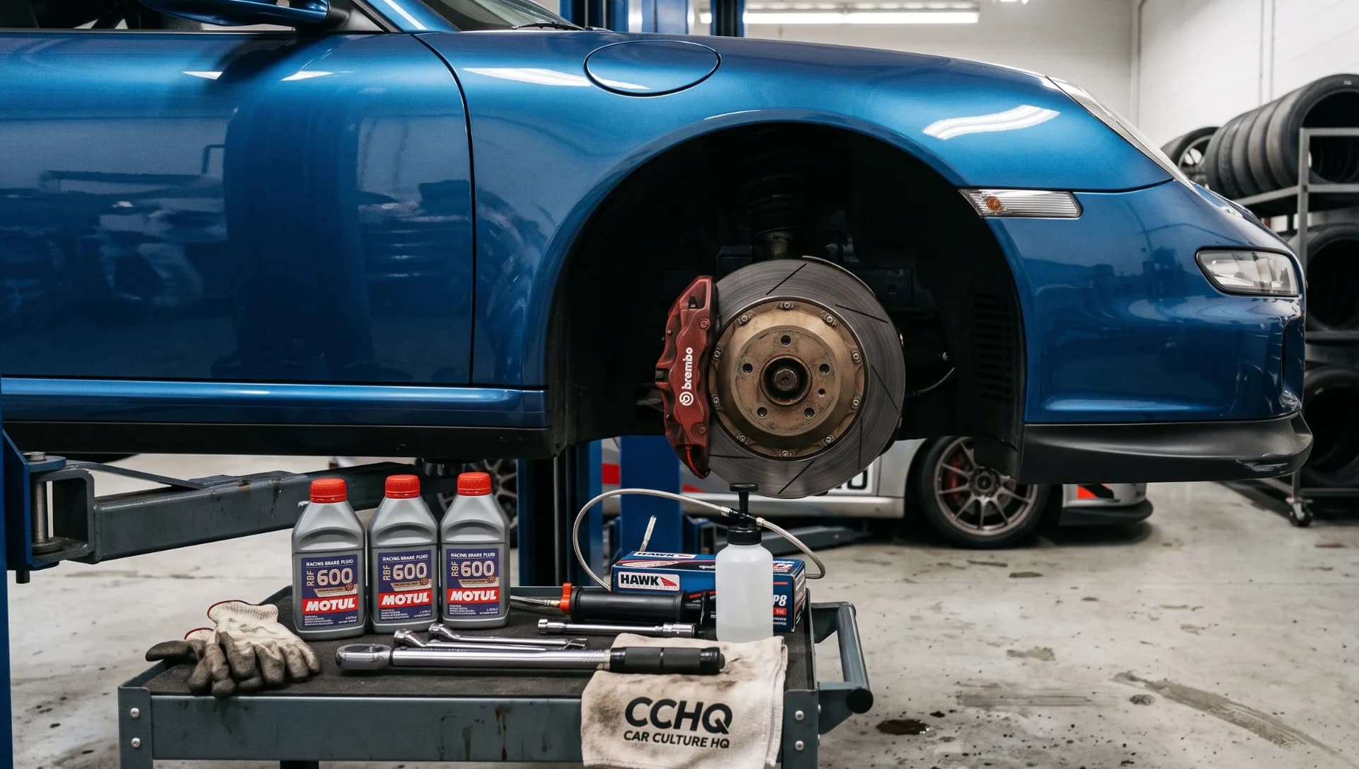 High performance brake pad and racing brake fluid setup on a track car build inside a working garage